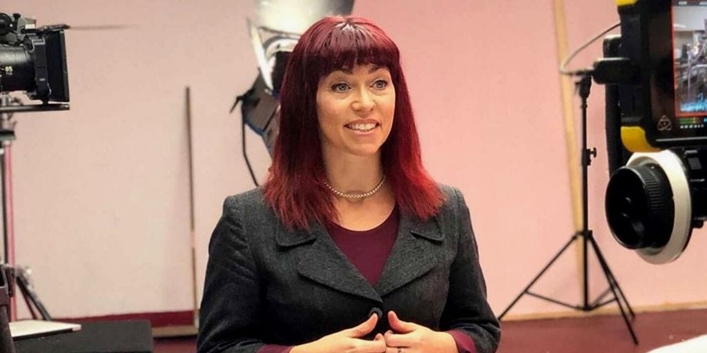 Image shows Toni Vernelli, a white woman with red hair