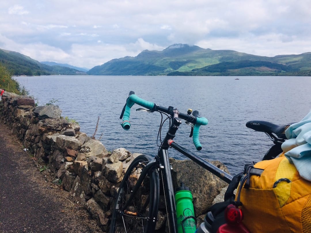 Image shows Anna's bicycle leaning against the wall overlooking Loch Lomond in Scotland