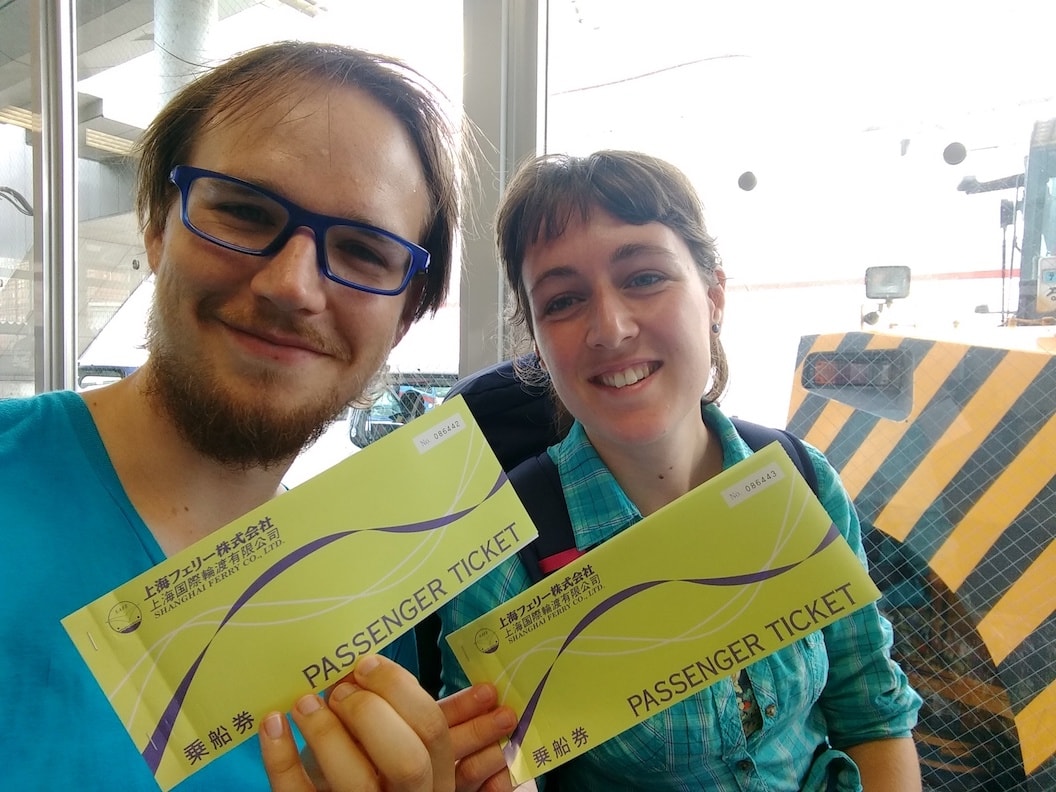 Mischa and Rosanna holding their ferry tickets