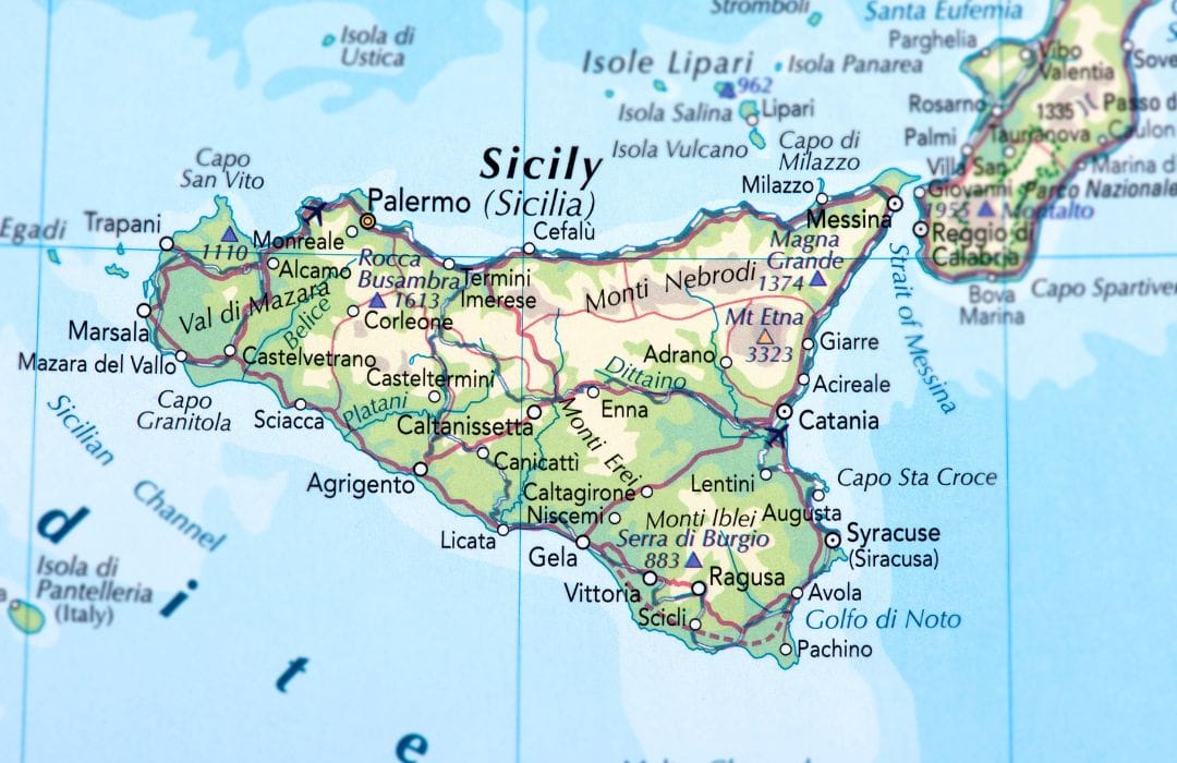 The picture shows a closeup shot of a map of Italy, with Sicily at the bottom. 